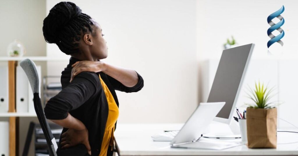 woman sitting in a chair and grabbing her shoulder