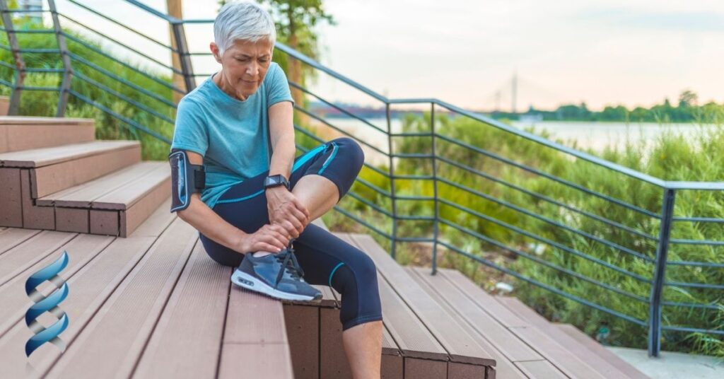 A woman holding her ankle in pain