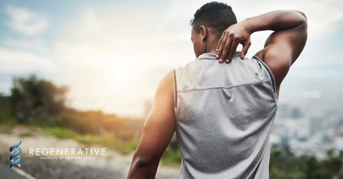 A man reaching for his back in pain while exercising