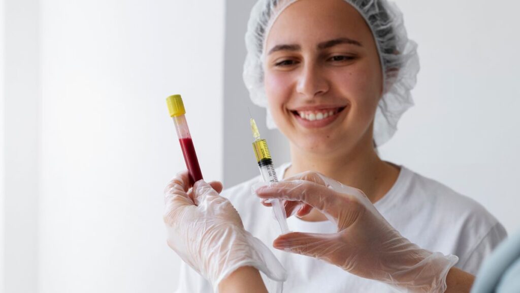 A woman in a white lab coat confidently holds a syringe, ready for a medical procedure or vaccination.