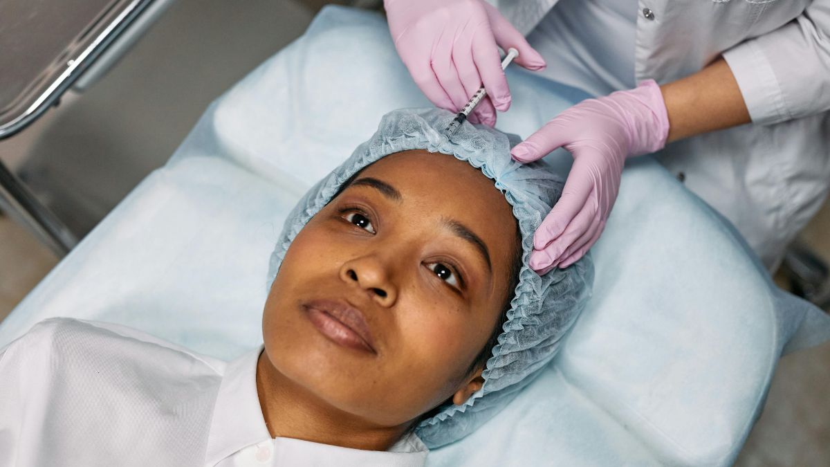 . Individual undergoing a facial injection, highlighting a cosmetic treatment in progress.